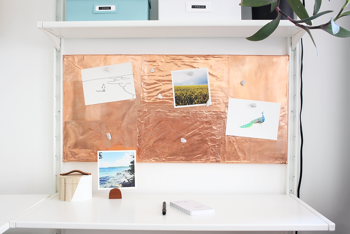 Love this Scandinavian workspace makeover with white open shelves, plenty of storage for craft supplies, and a gorgeous DIY copper inspiration board.