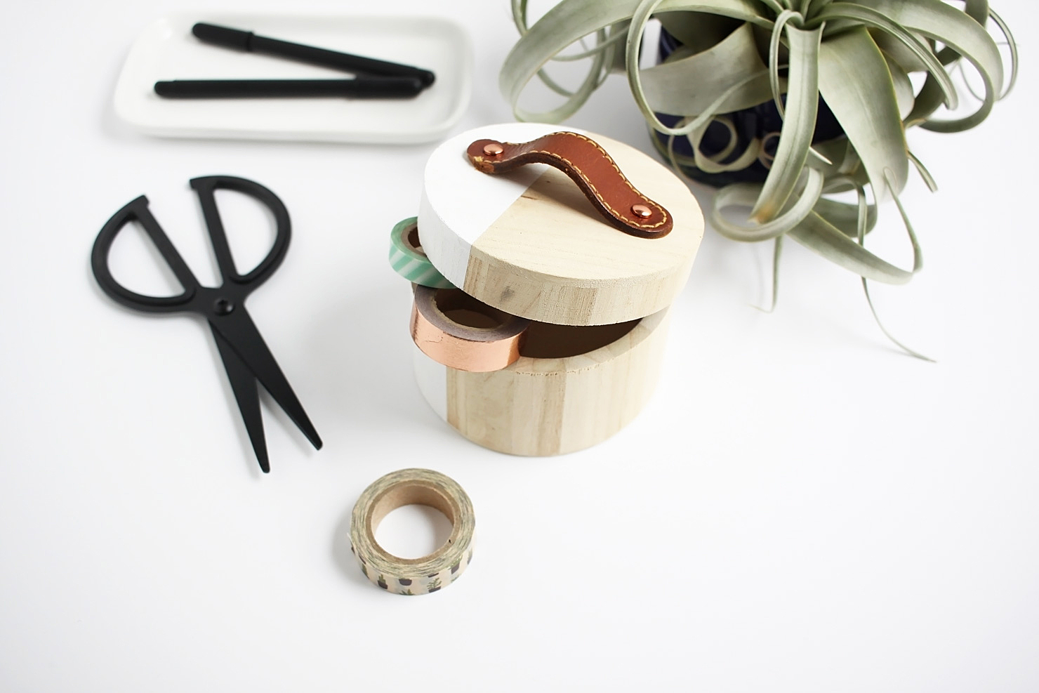 Turn a thrifted leather belt into a simple handle for a modern storage box. Perfect for your favorite washi tape.