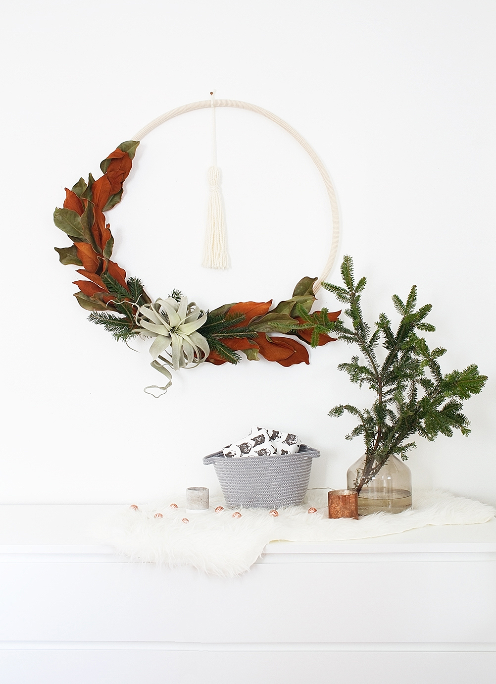 DIY Boho Winter Wreath made from a hula hoop - such a beautiful touch for your modern Scandibo holiday decor!