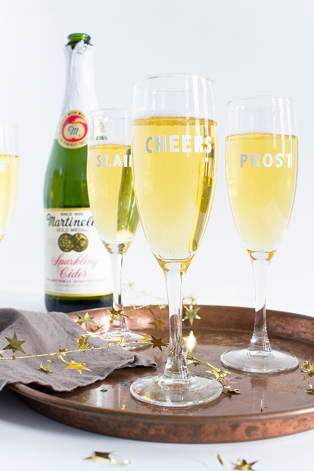 Get festive with this 5 minute New Year's Eve party hack! These DIY Cheers Champagne Flutes are super quick, and all you need are stickers!