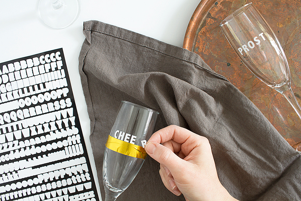 Get festive with this 5 minute New Year's Eve party hack. These DIY Cheers Champagne Flutes are super quick, and all you need are stickers!