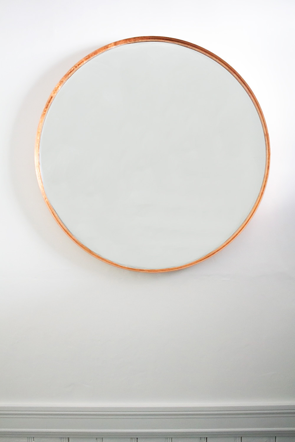 You can turn any plain mirror into a DIY copper mirror on a budget using just copper leaf and a paintbrush. The perfect low-budget craft for a high-end look!