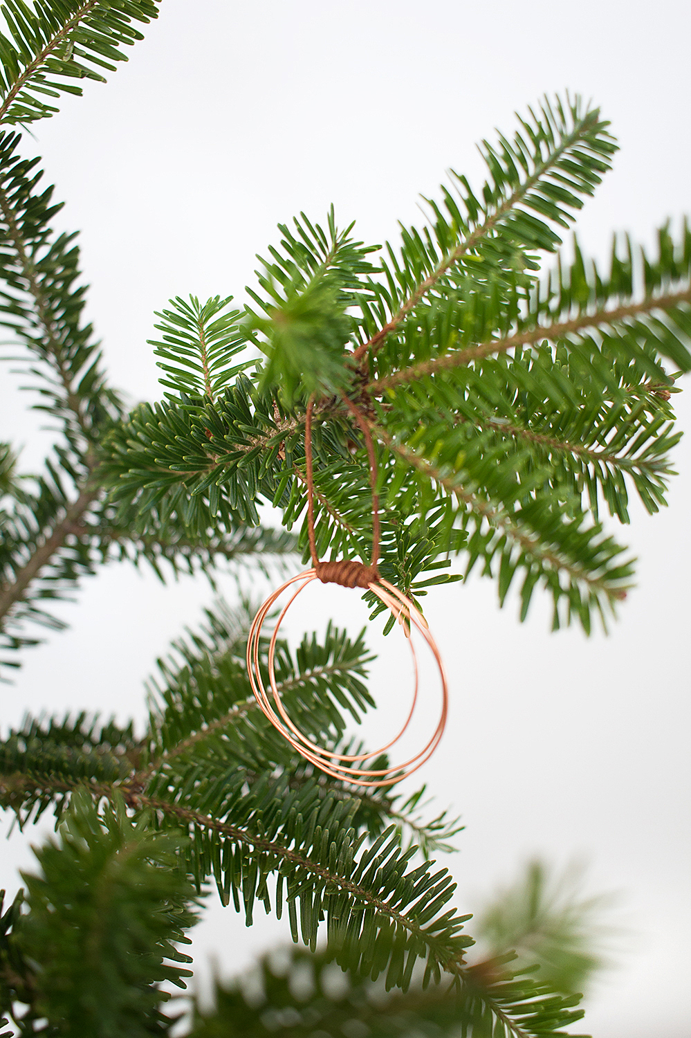 Whip up these DIY Copper Wire Hoop Ornaments in just ten minutes for a little boho bling on your tree.