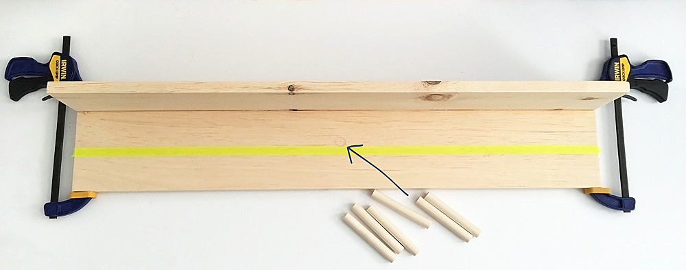 This minimal DIY entryway coat rack is simple to make with a power drill and just a few supplies. Dowel pegs can hold your bags and jackets and a shelf can catch your keys and provide a spot for decoration!