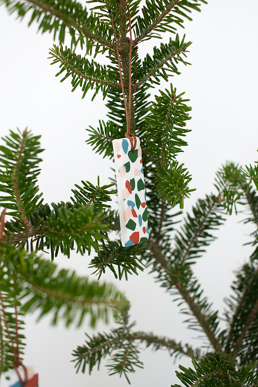 Make these easy and fun DIY terrazzo tile ornaments for a modern, colorful addition to your holiday decor.