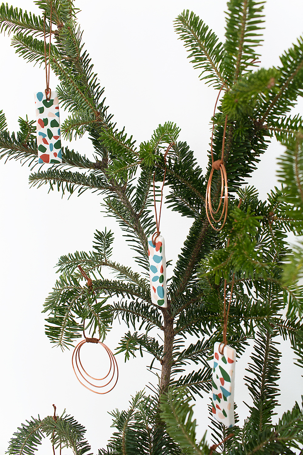Add a little boho bling to your holiday decor with these easy DIY Copper Wire Hoop Ornaments that take just ten minutes to make!