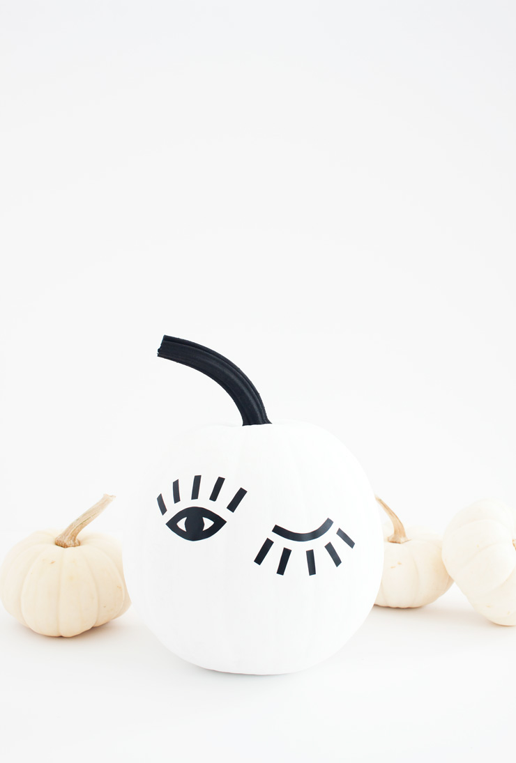 You can make this DIY winking eye pumpkin in just 30 minutes using black contact paper and a free printable template!